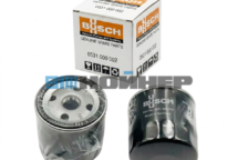 Box of Busch genuine spare parts with two vacuum pump components displayed in front